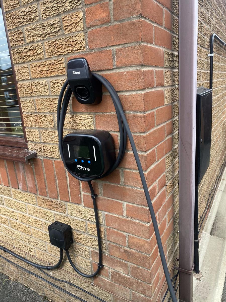 Ohme charger on a corner wall